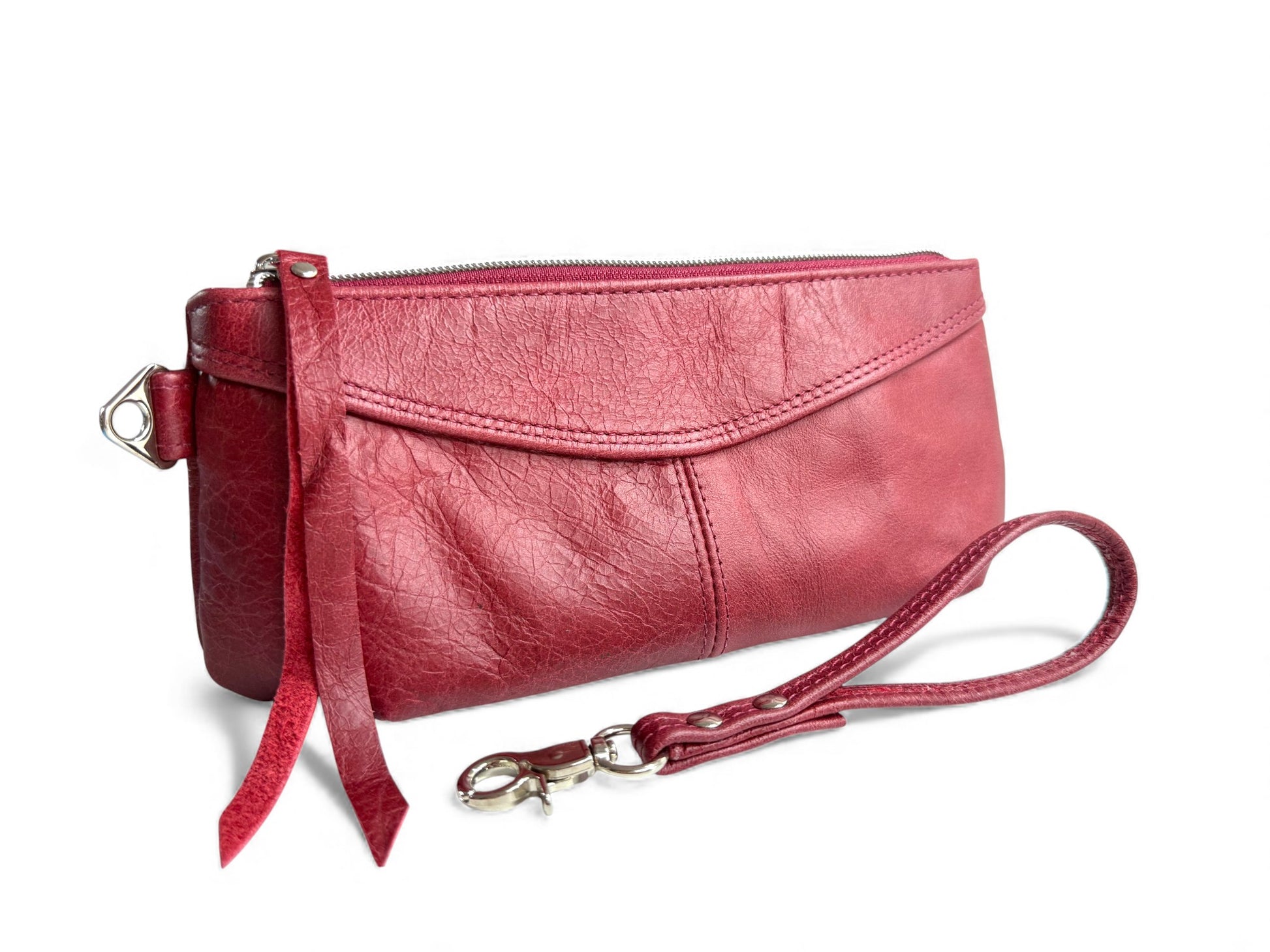 The Ella clutch bag with a matching leather wrist strap on a white background. Handcrafted from rescued leather