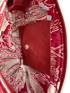 Close-up view of the interior of the Ella clutch bag with integrated purse with silver press stud.