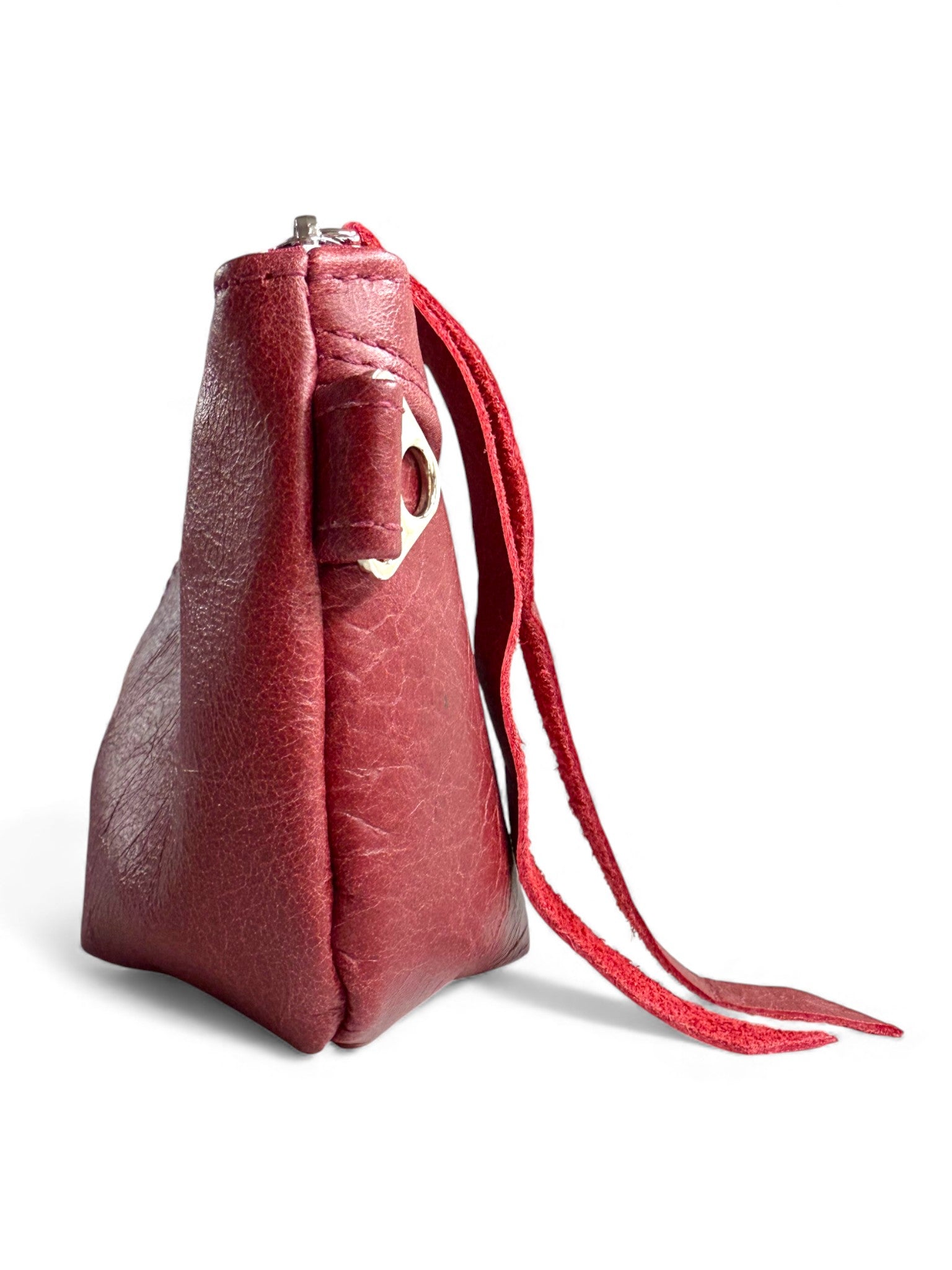 Side view of the Ella evening bag. Red leather handbag  on a white background. The image highlights the silver strap connector on the side