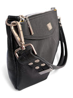 Side view of the Elland handbag, handmade using black, rescued leather. Image shows the detail of th silver hardware on a white background
