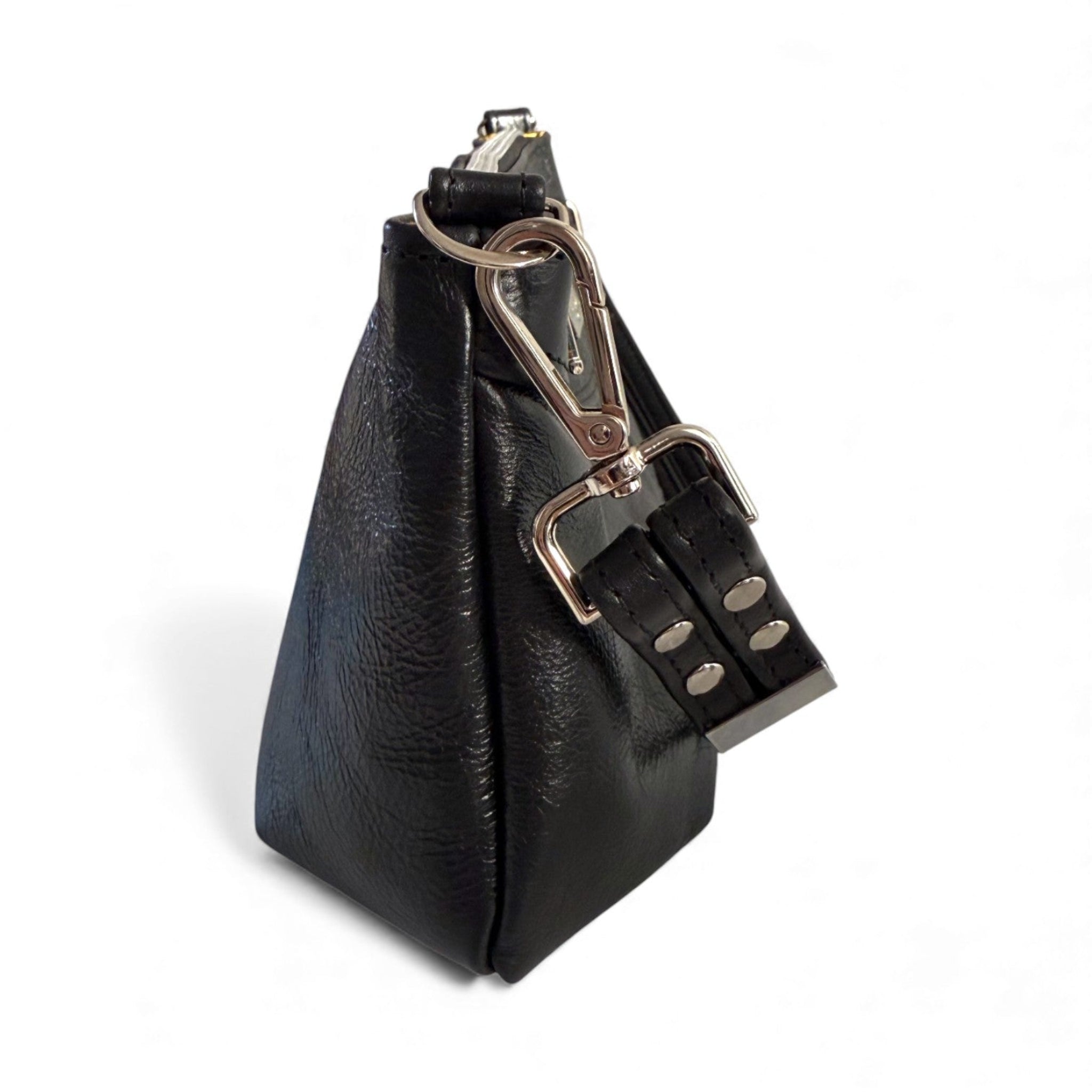 Side on view of the Elland Baguette bag. The image shows a close up of the side seam, the texture of the black rescued and the silver hardware and strap buckle on a white background