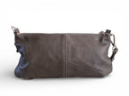 View of the back of a dark grey leather handbag on a white background