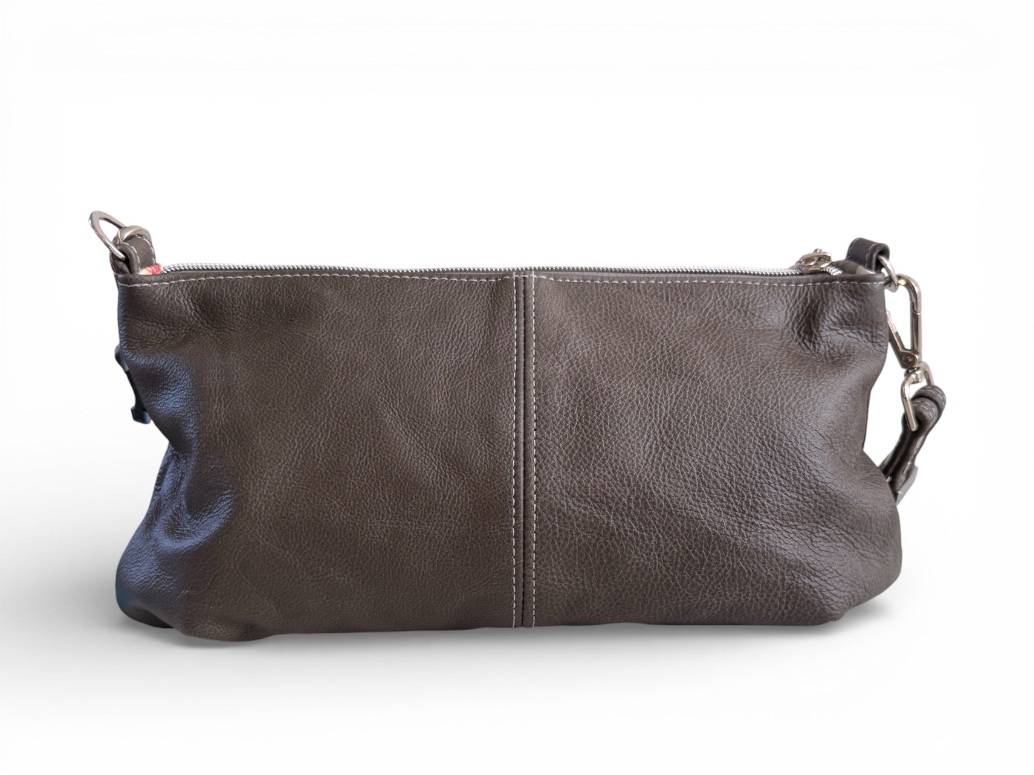 View of the back of a dark grey leather handbag on a white background