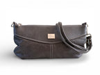 Gray leather handbag with a visible brand label on a white background