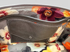 Interior view of the Elland bag, showing Floral-patterned lining with a grey leather integrated purse