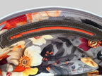 Interior view of the floral-patterned lining with an orange zipper 