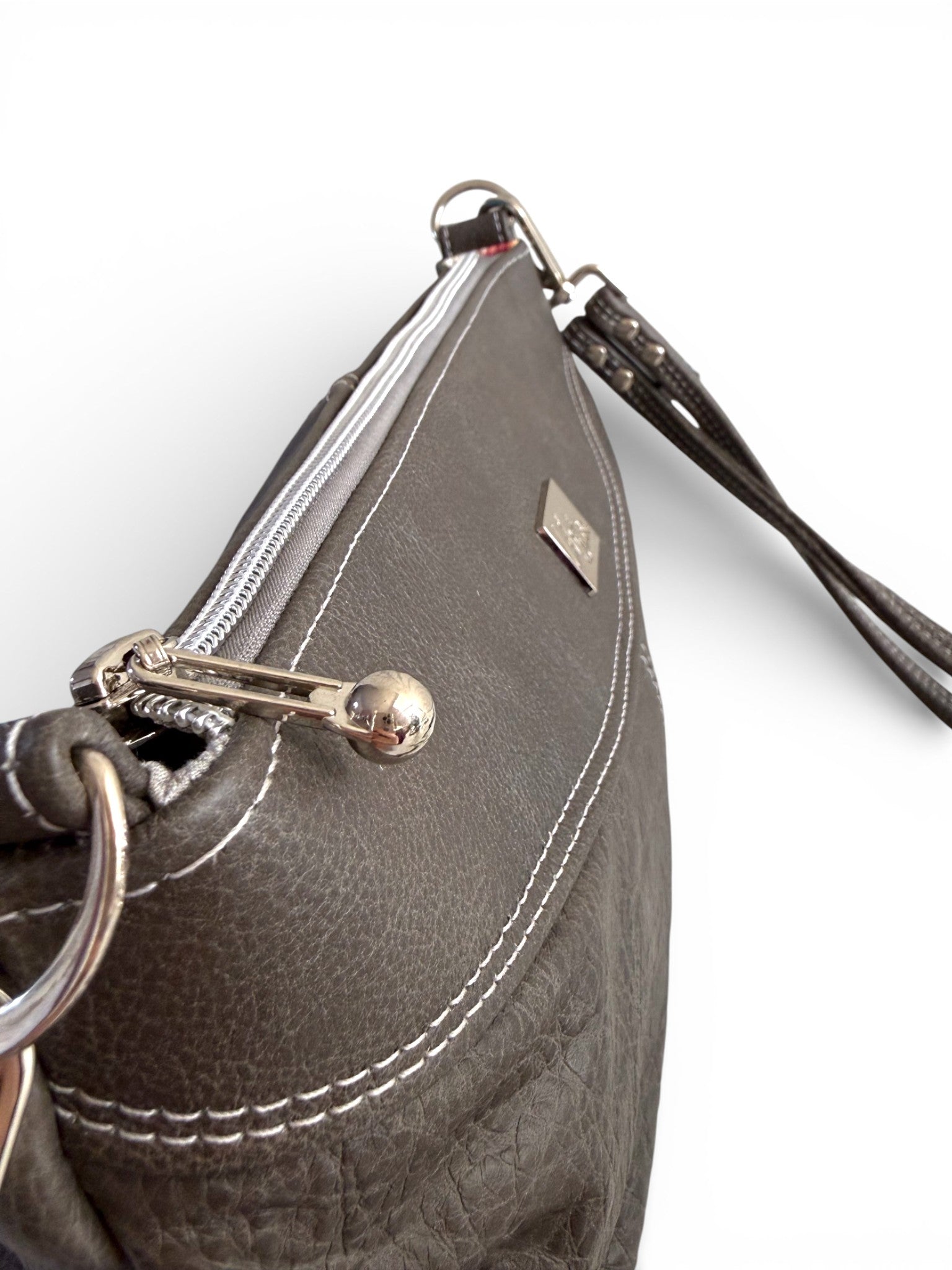 Close-up of a gray handbag withsilver hardware and a visible Lilly & Jude logo on a white background
