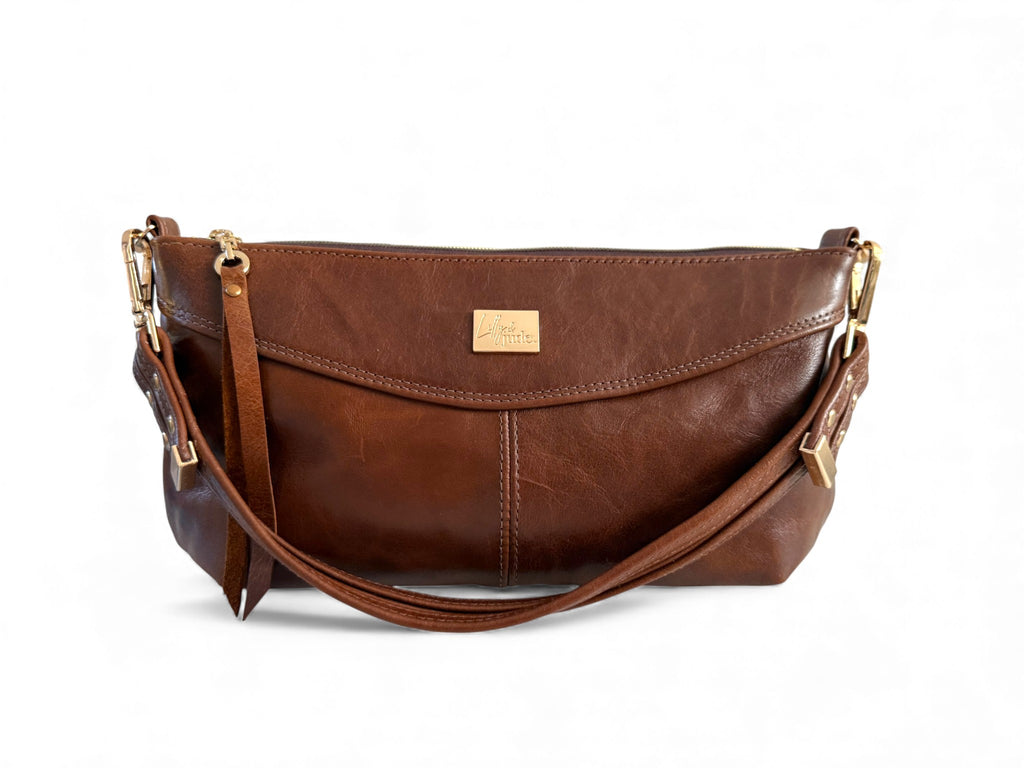 Brown leather Elland handbag, with gold hardware on a white background. Handcrafted using rescued leather