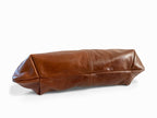 Brown leather clutch bag on a white background