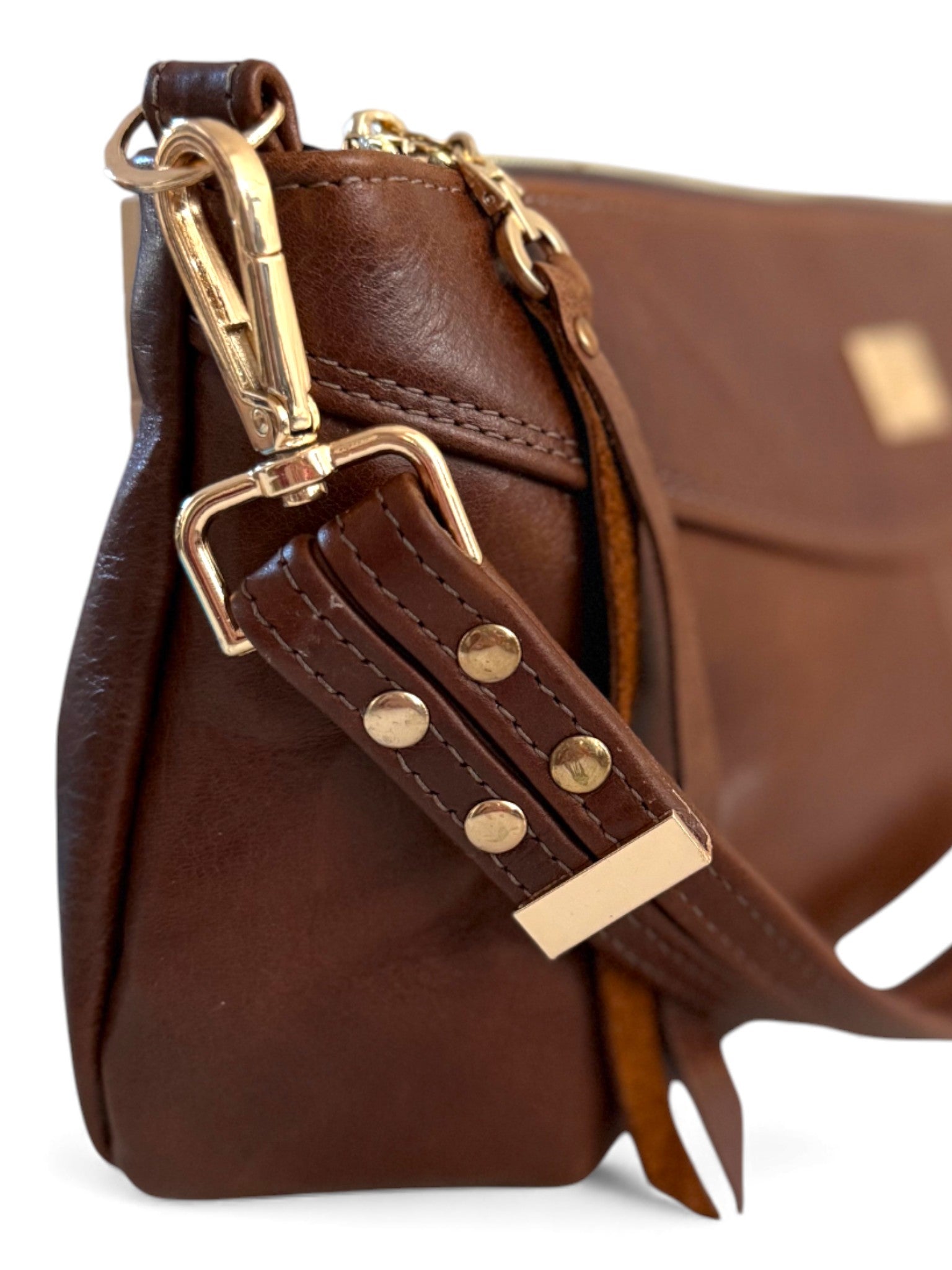 Brown leather bag with gold hardware on a white background
