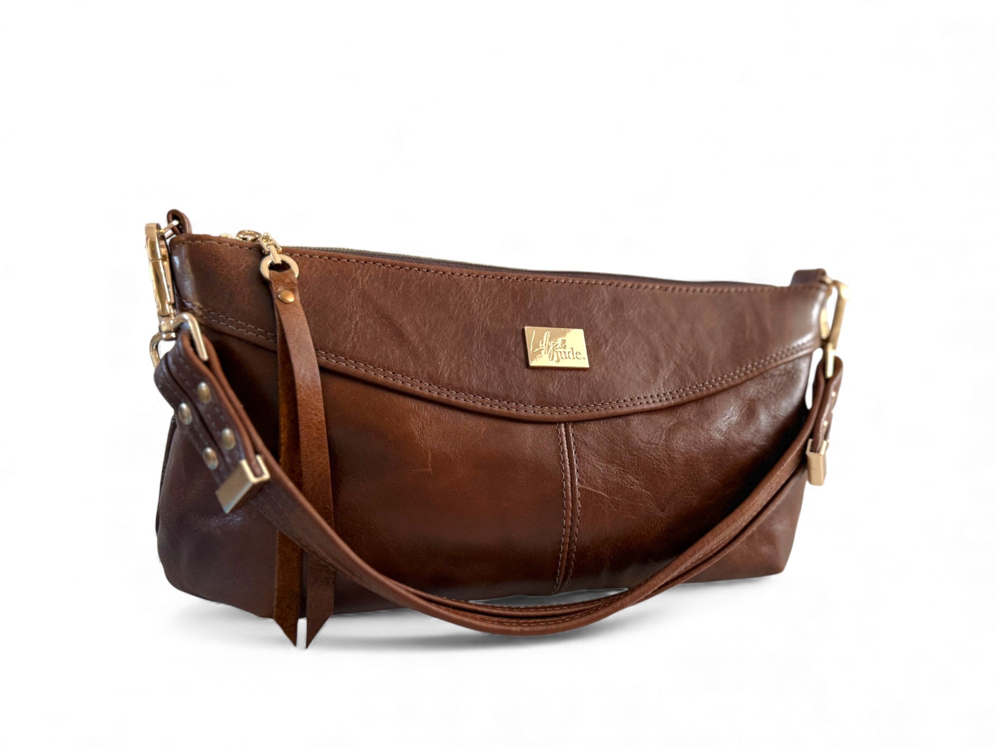 Brown leather handbag with gold accents on a white background
