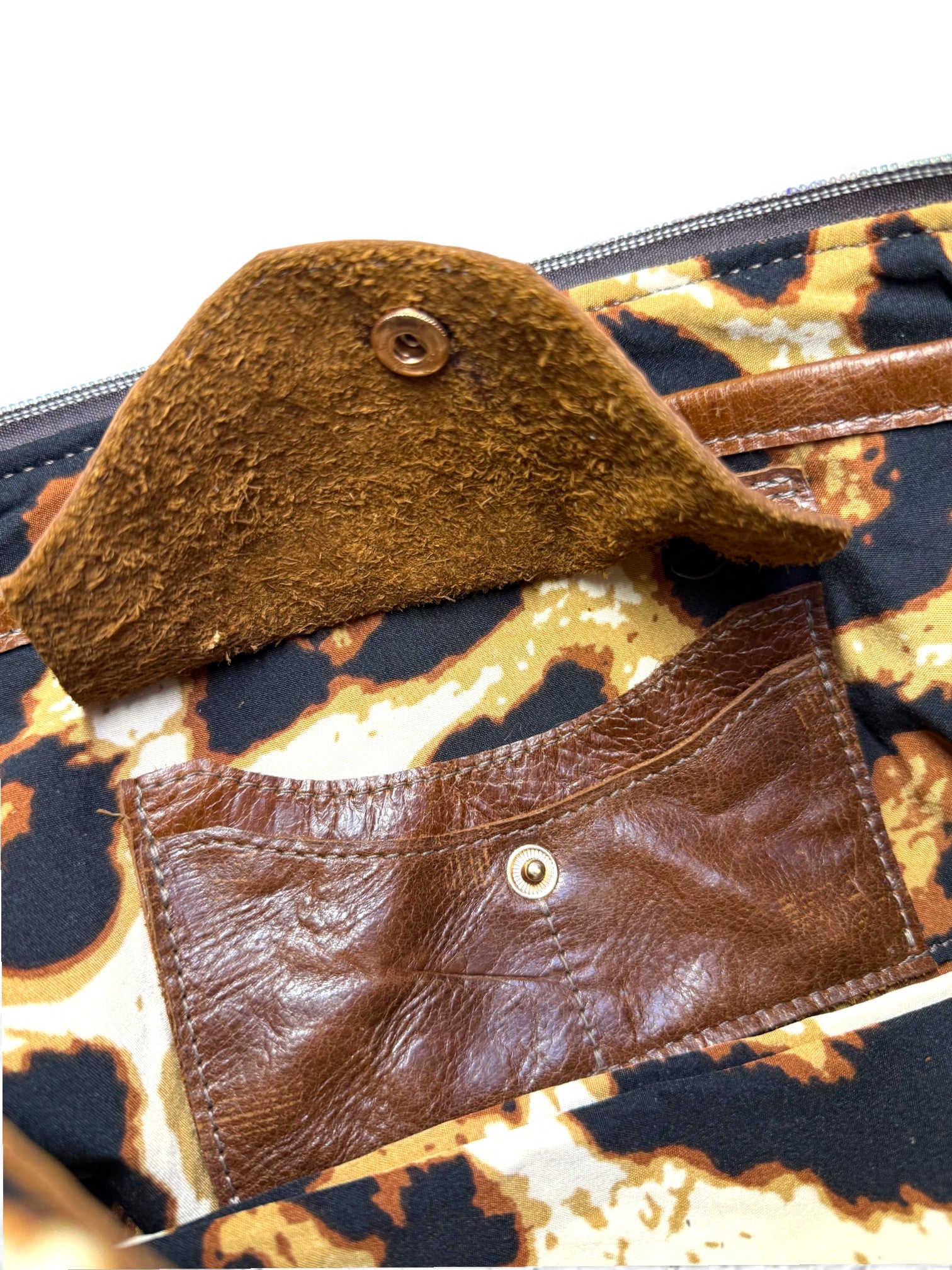 Brown leather handbag with a leopard print lining and leather integrated purse
