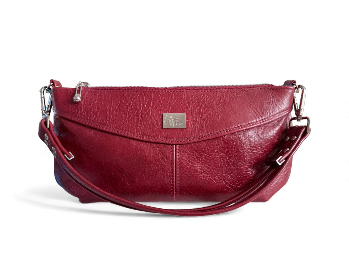 Red leather Elland handbag with a silver Lilly & Jude brand logo on a white background. Made from rescued leather for sustainable fashion and accessories