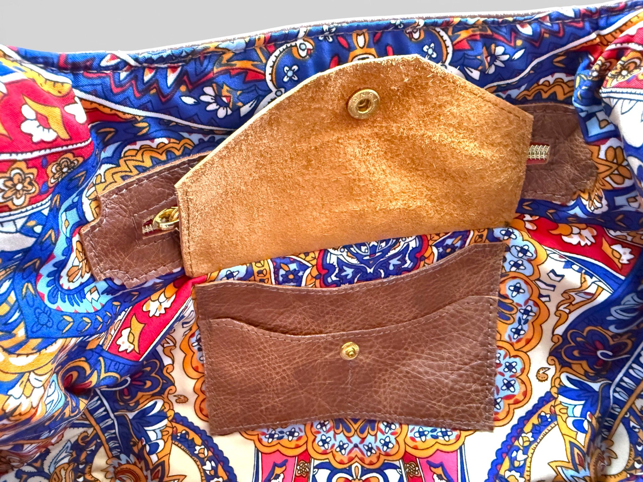 Inside view of the Estrella slouchy tote bag, highlighting the Lilly & Jude signature integrated purse, showing the space for bank cards, cash and coins. The image also shows the stunning lining of the bag