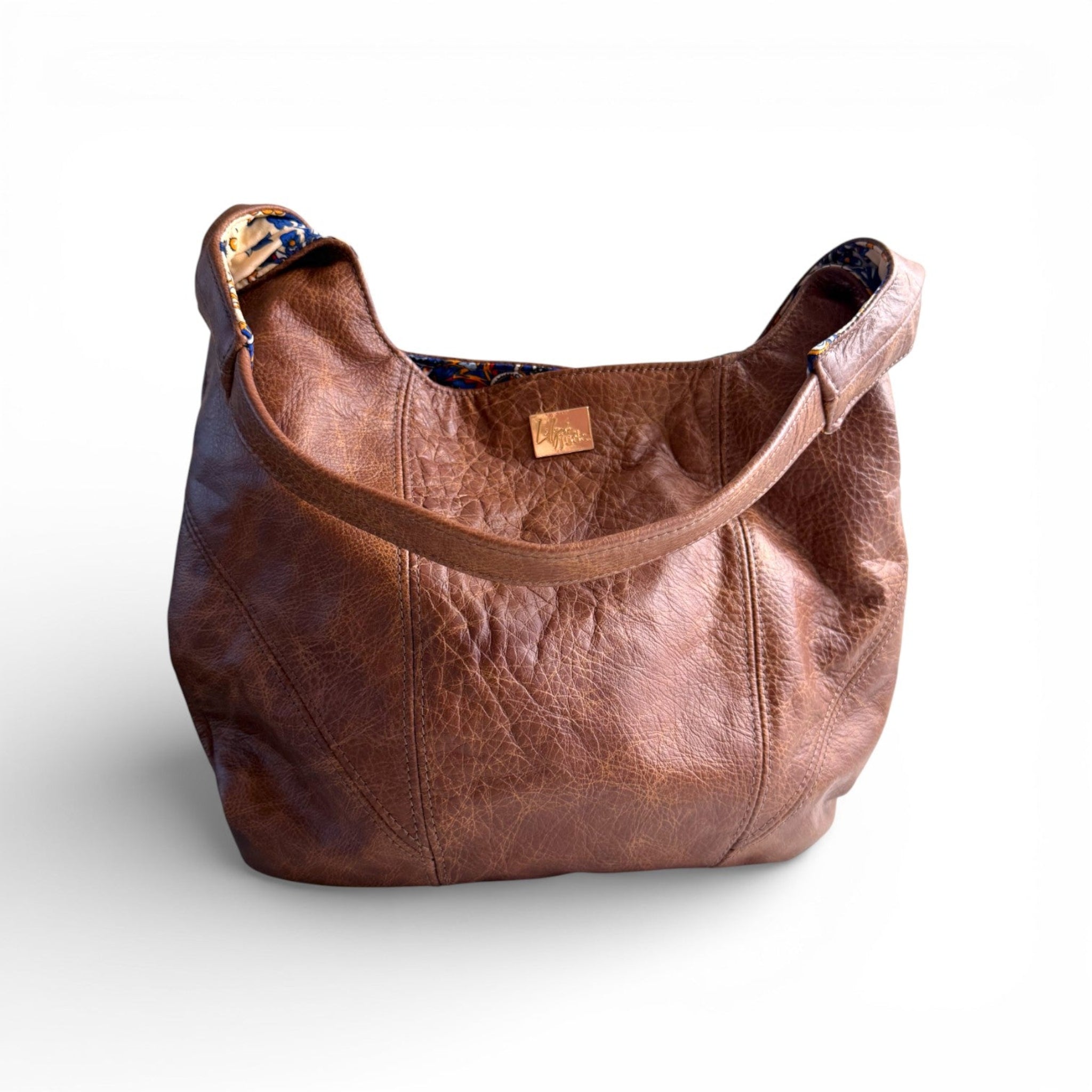 Brown leather Estrella tote style handbag on a white background