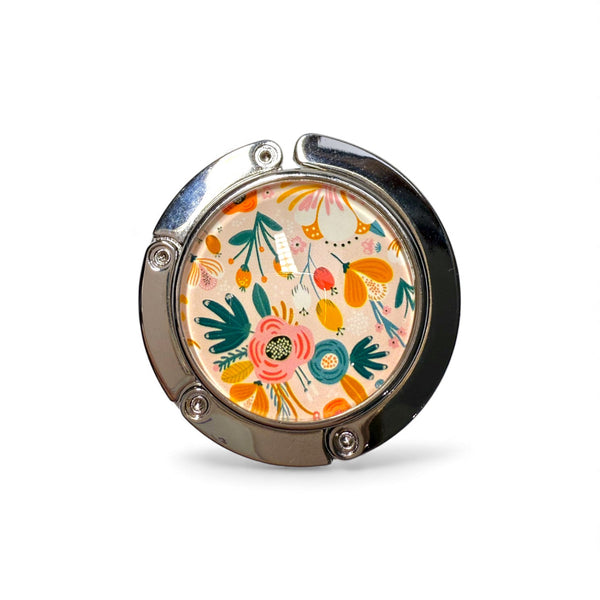 Floral patterned handbag hook on a white background
