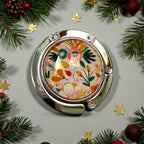 Floral-patterned handbag hook surrounded by Christmas decorations on a light gray background