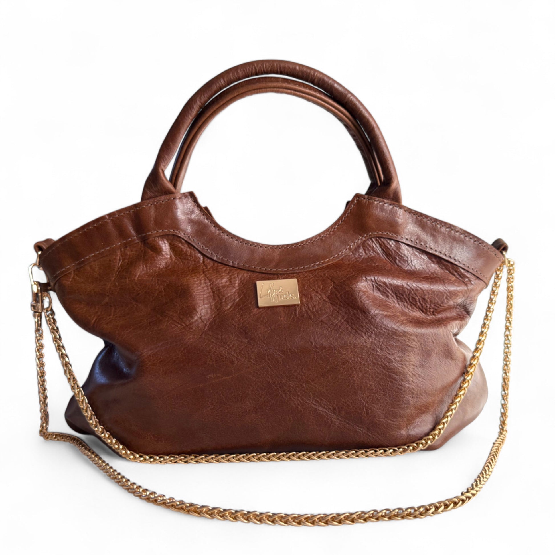 Brown leather handbag with a gold chain on a white background. Handcrafted by Lilly & Jude
