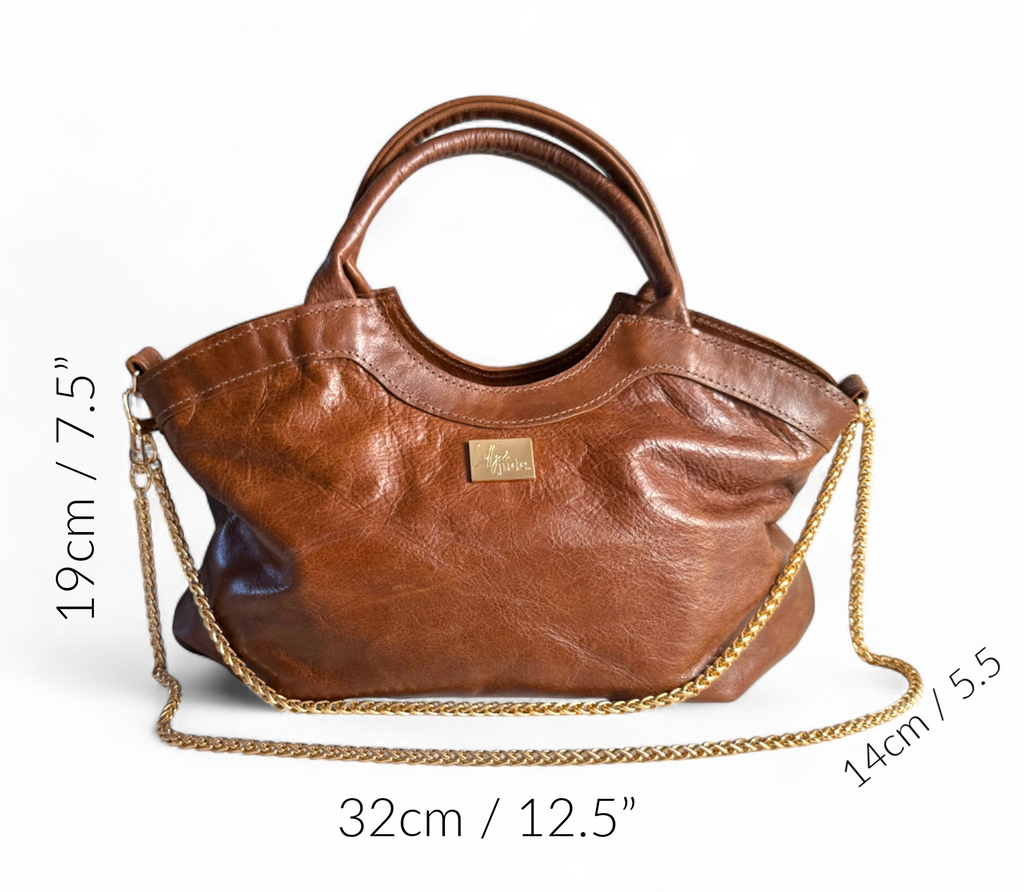 The Flossy, brown leather handbag with gold chain detail and measurements on a white background