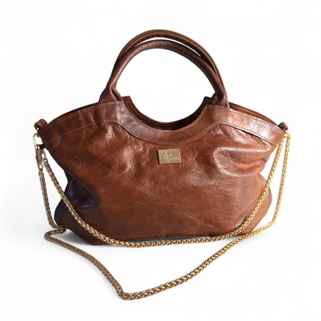 Handcrafted, brown leather handbag with gold chain strap on a white background. Handcrafted in Shropshire by Lilly & Jude