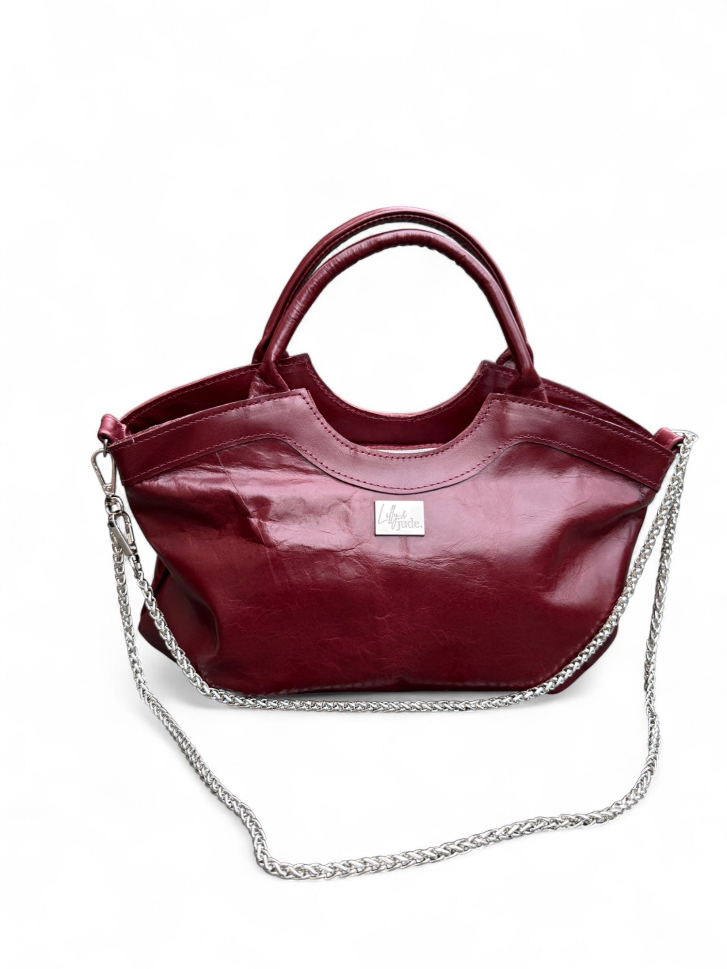Maroon handbag with a chain detail on a white background