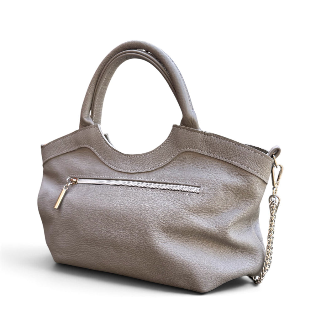 A grey leather handbag with dual top handles, a curved top edge, a zippered pocket, and a silver-tone chain strap, shown on a white background.
