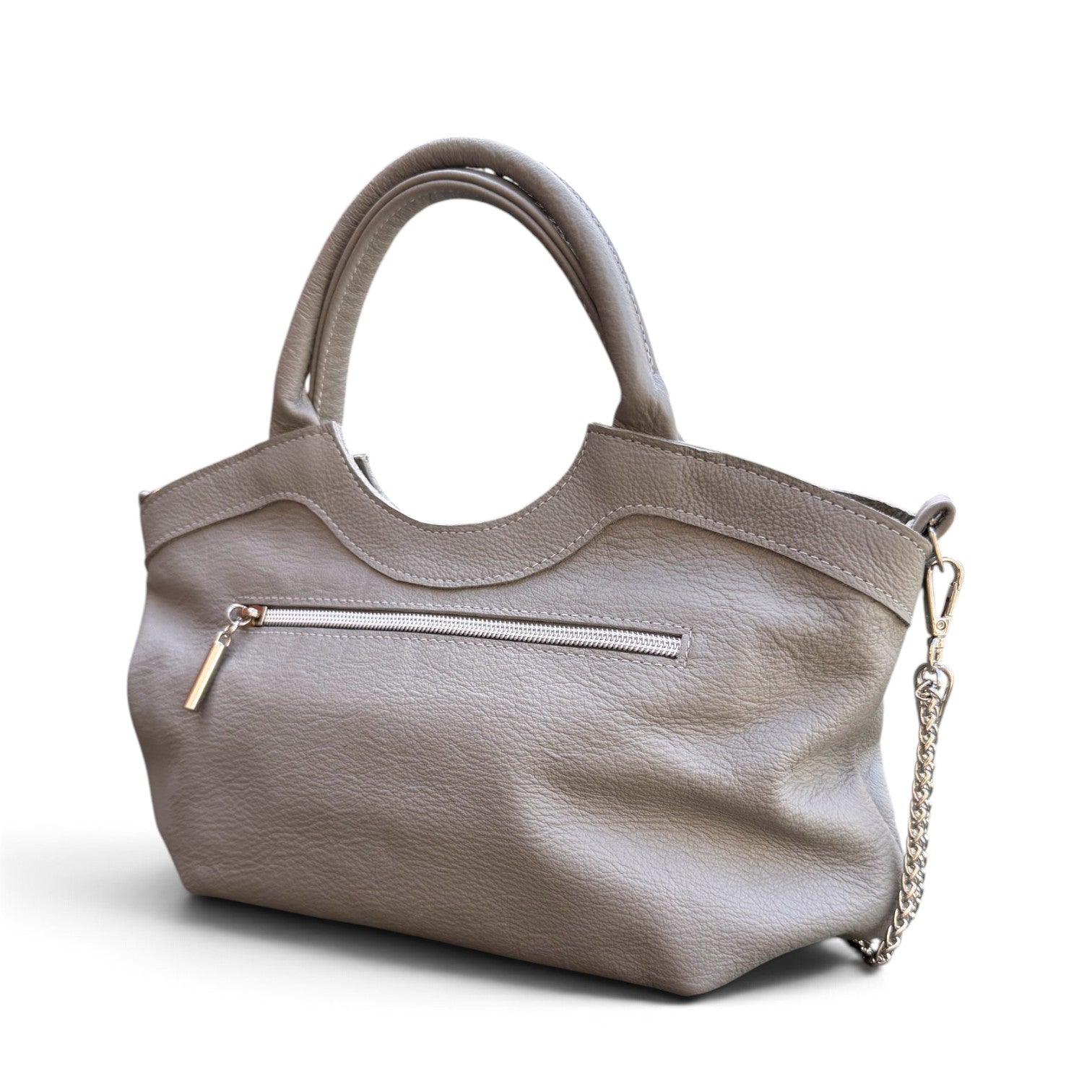 A grey leather handbag with dual top handles, a curved top edge, a zippered pocket, and a silver-tone chain strap, shown on a white background.