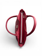 An overhead view of the Flossy handbag with the handles open, to show the zipper opening at the top of the bag. It also shows the visible Lilly & Jude  brand logo on a white background