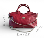 Red, reduced leather handbag with a silver chain detail and measurements on a white background