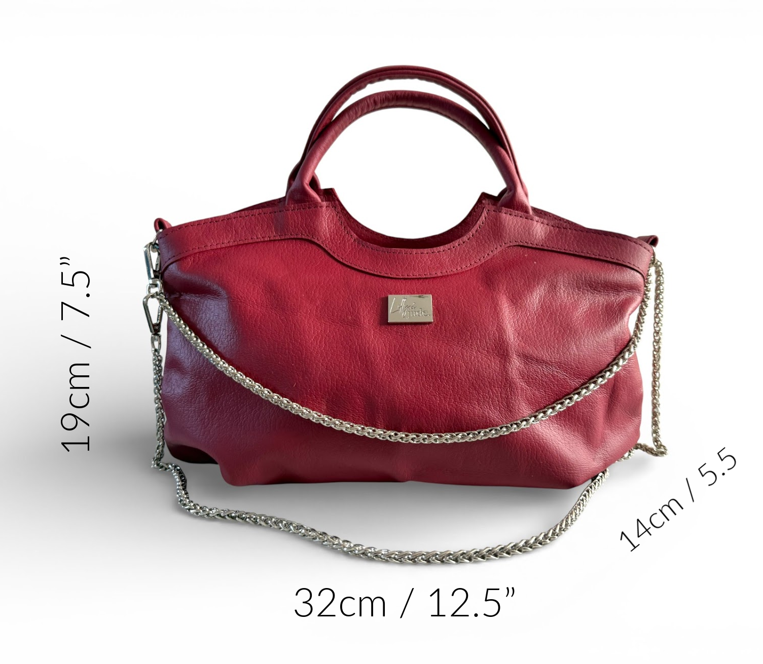 Red, reduced leather handbag with a silver chain detail and measurements on a white background