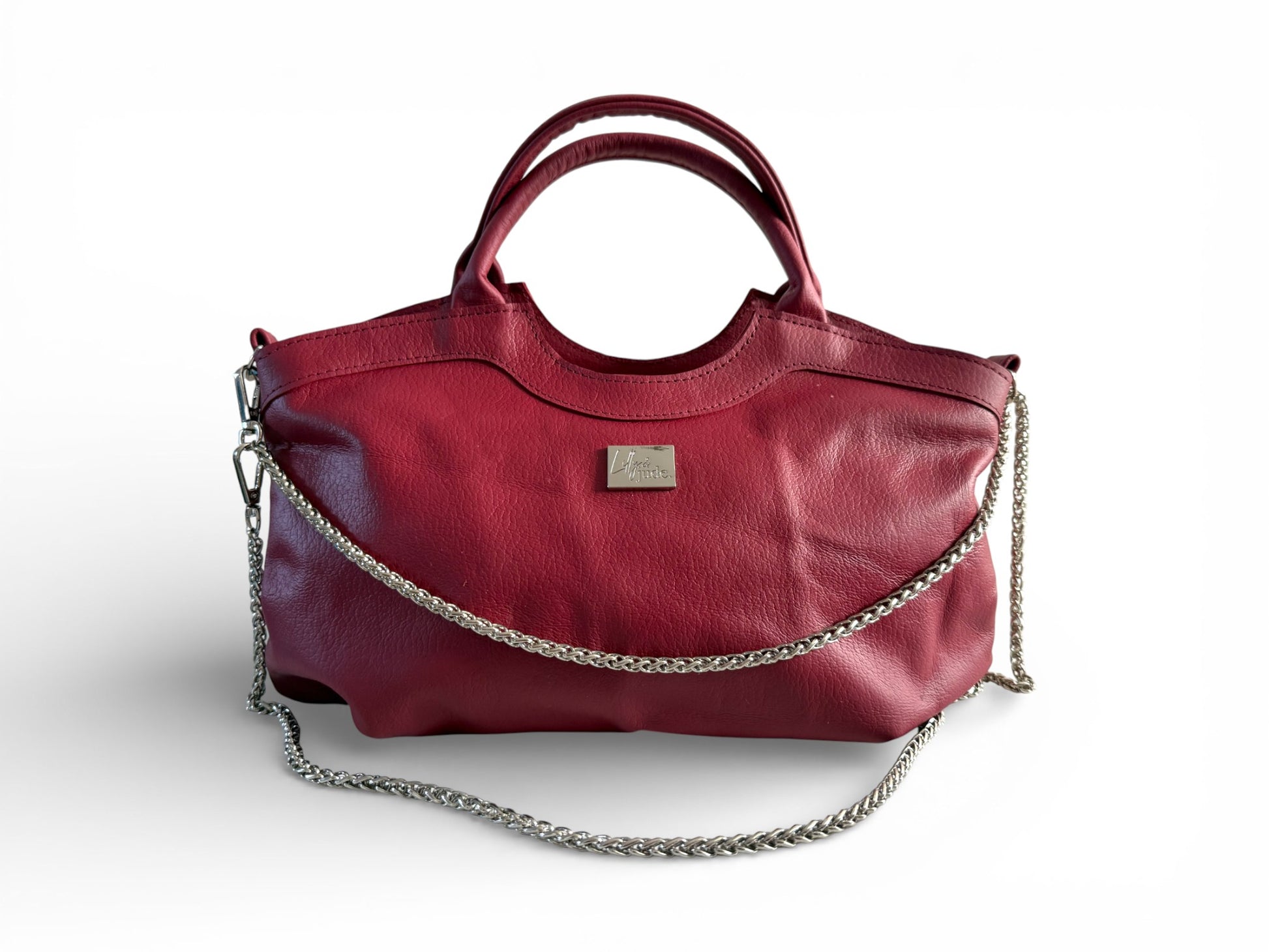 Red leather handbag with a chain detail on a white background. The Flossy handbag is made from leather which has been rescued from heading to landfill