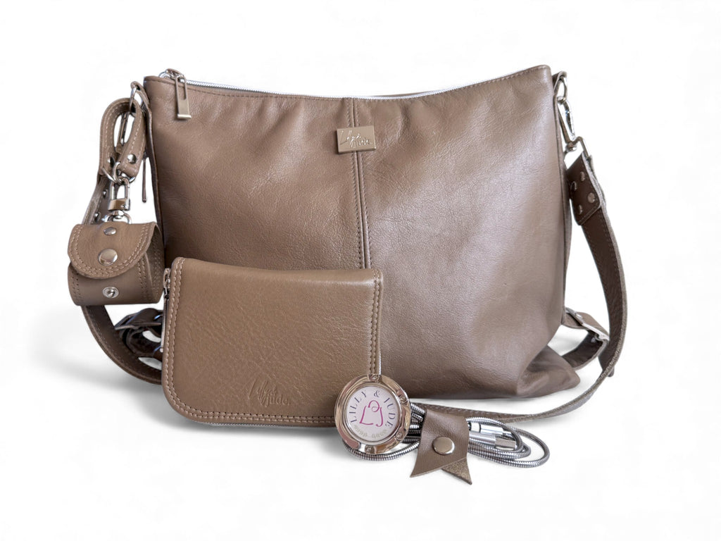 Taupe grey leather handbag with matching wallet, cord keeper, accessory cuff and bag hook on a white background