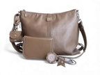 Taupe grey leather handbag with matching wallet, cord keeper, accessory cuff and bag hook on a white background