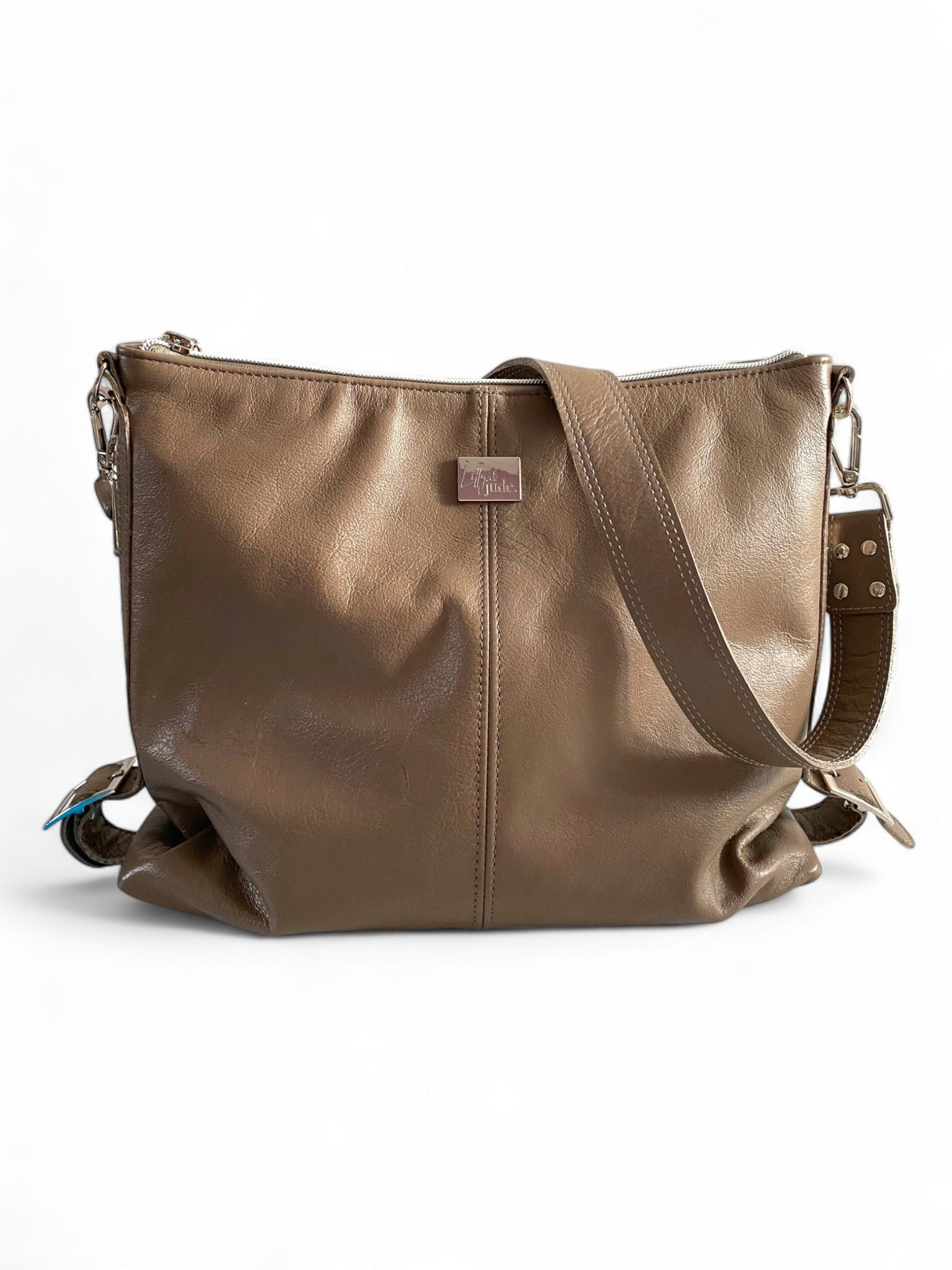 A taupe leather slouch handbag with a shoulder strap and silver hardware.