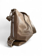 Taupe grey leather bag with a shoulder strap and silver hardware on a white background