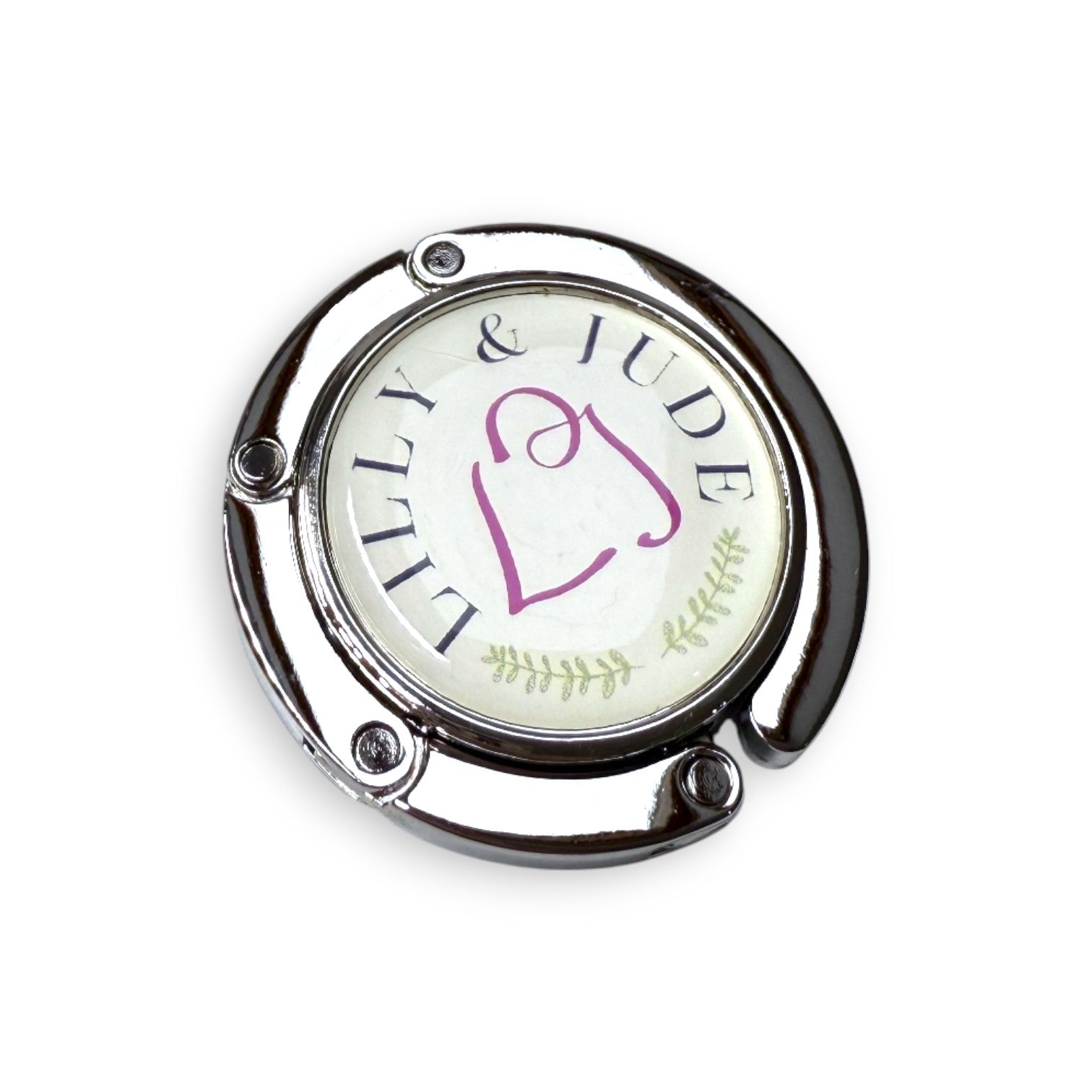 Round metal fold away bag hook with 'Lilly & Jude' branding on a white background