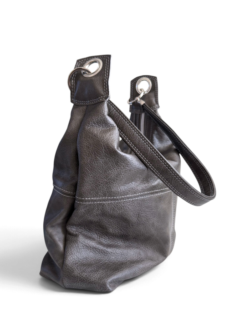 A dark gray pebbled leather shoulder bag with a matching shoulder strap and silver-tone metal grommets, shown on a plain white background.
