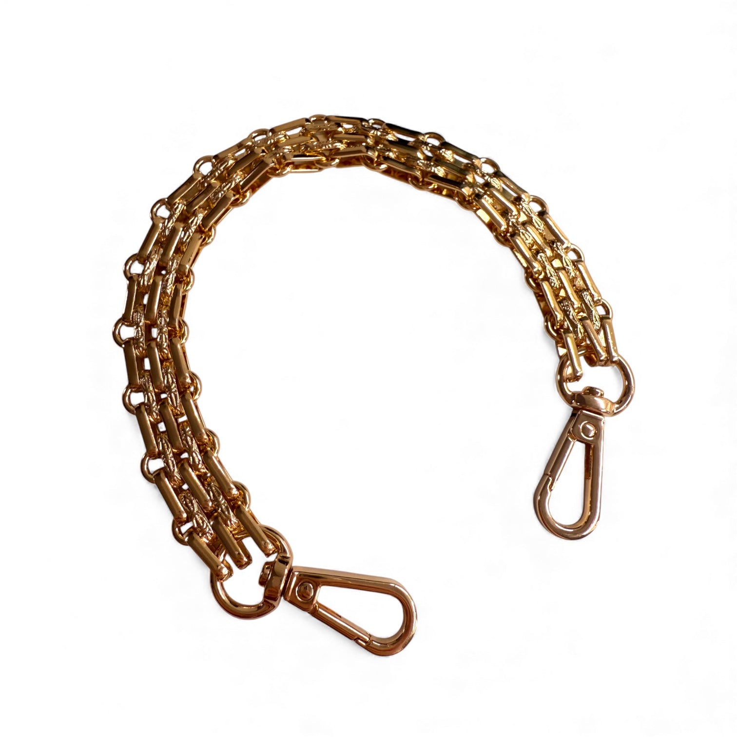 Gold chain bag handle strap with swivel hooks on a white background