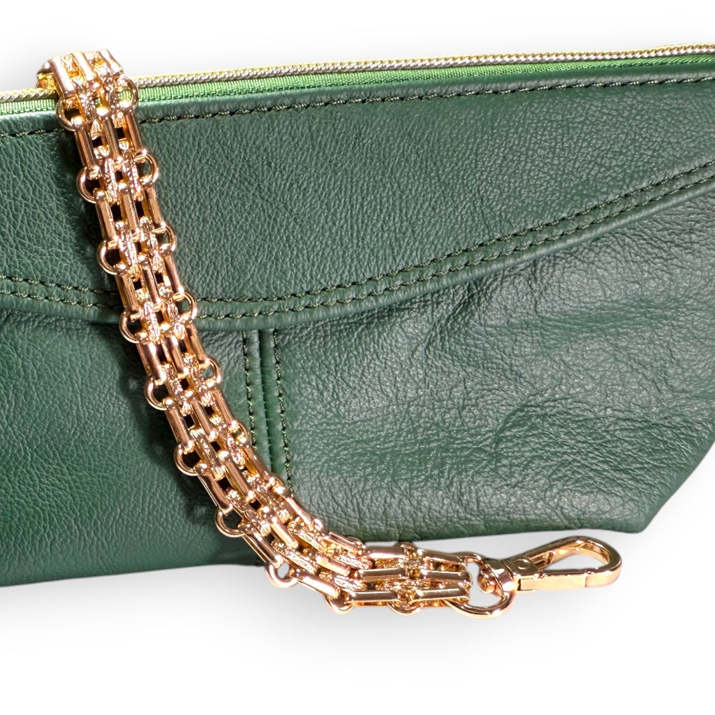 Green leather clutch with a gold chain strap on a white background