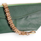 Green leather clutch with a gold chain strap on a white background