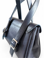 Black leather satchel with strap on a white background