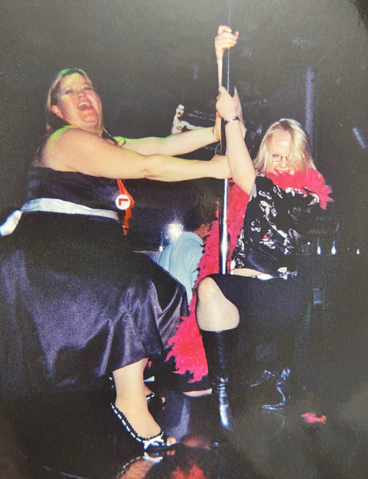 Two women in costumes doing a drunken dance around a pole on a drunken hen night! How embarrassing!
