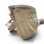 Side view of a butter yellow, pebbled leather crossbody bag with silver zippers and a matching woven strap, shown on a white background.