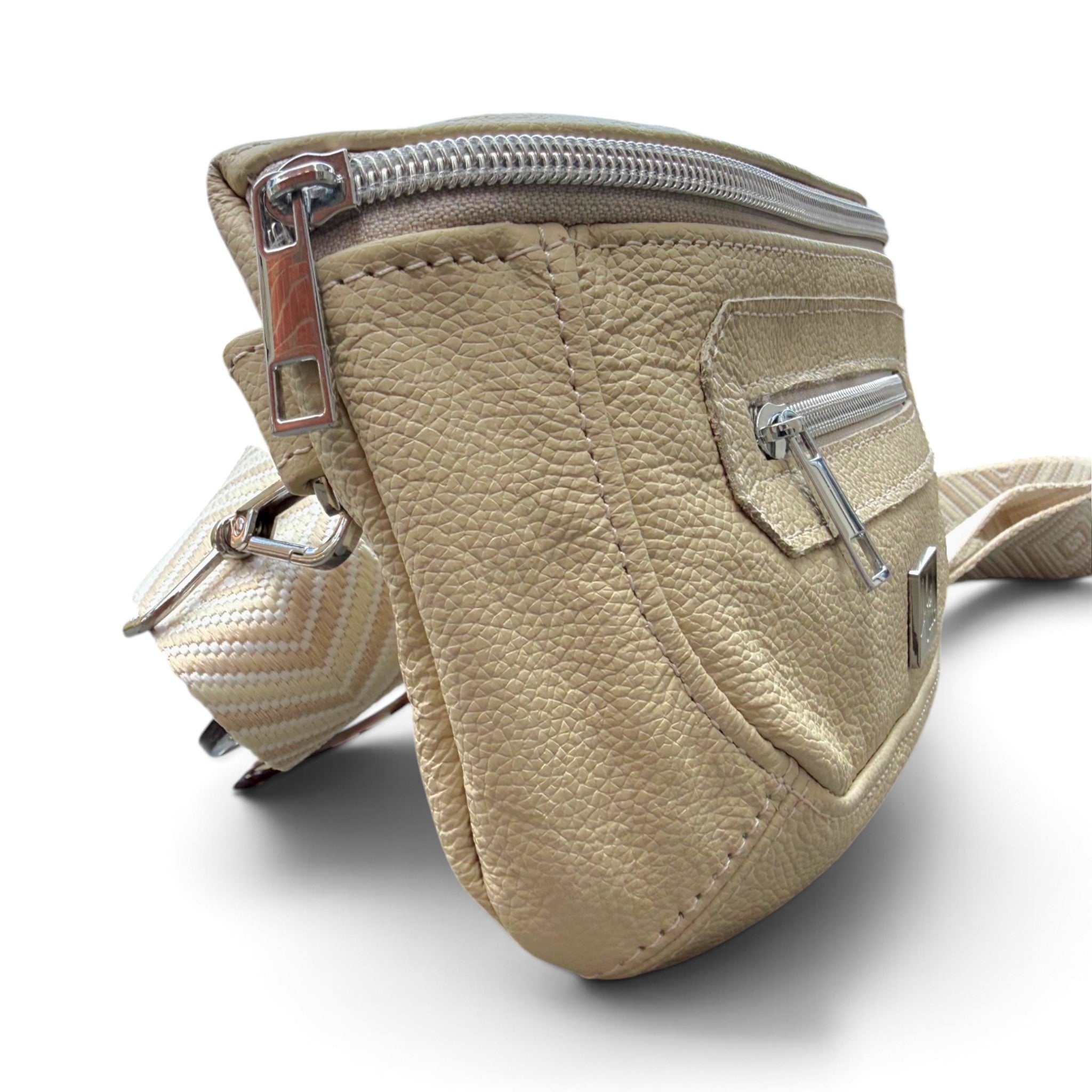 Side view of a butter yellow, pebbled leather crossbody bag with silver zippers and a matching woven strap, shown on a white background.