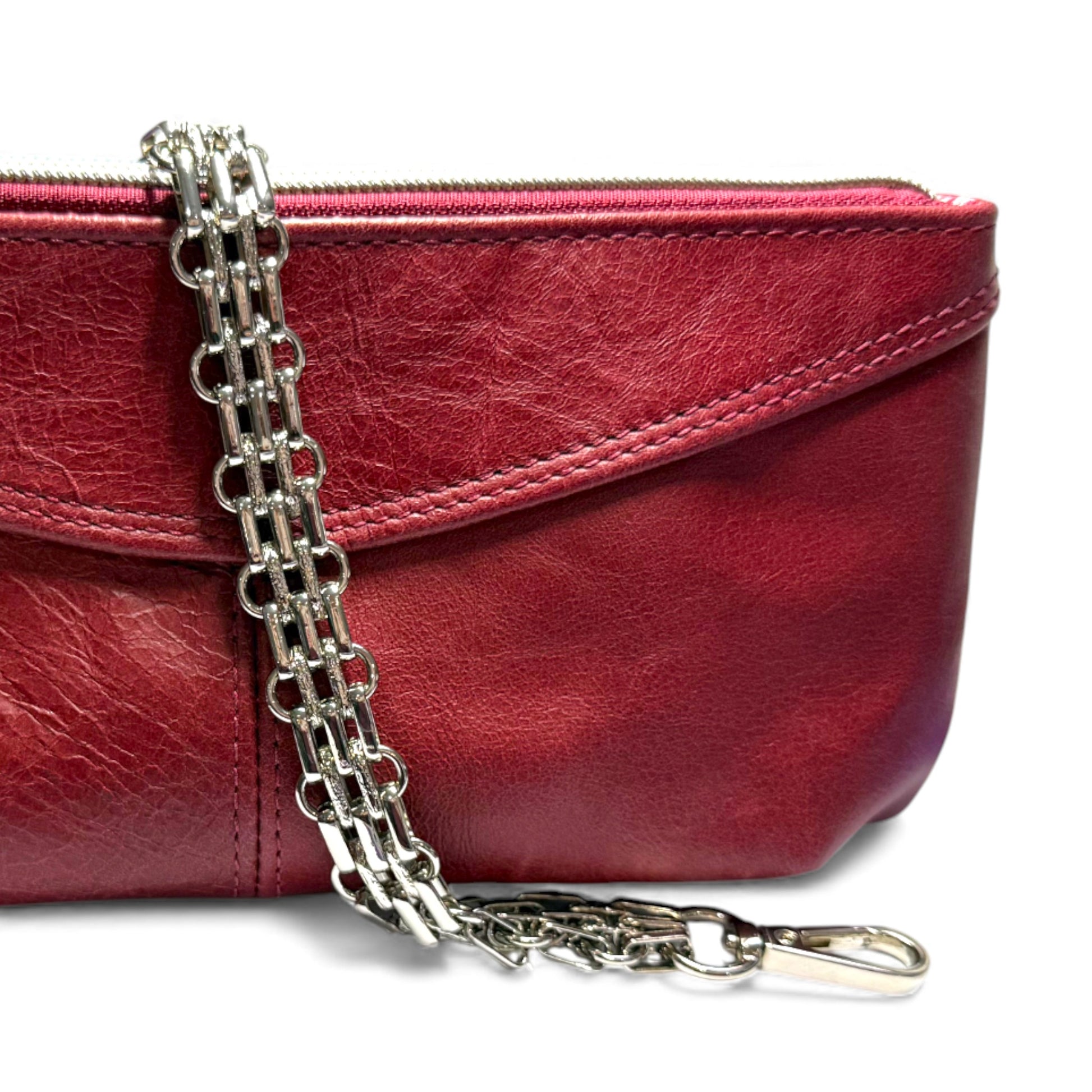 The silver multi-row, bracelet style wrist strap, draped over the Ella bag, against a white background