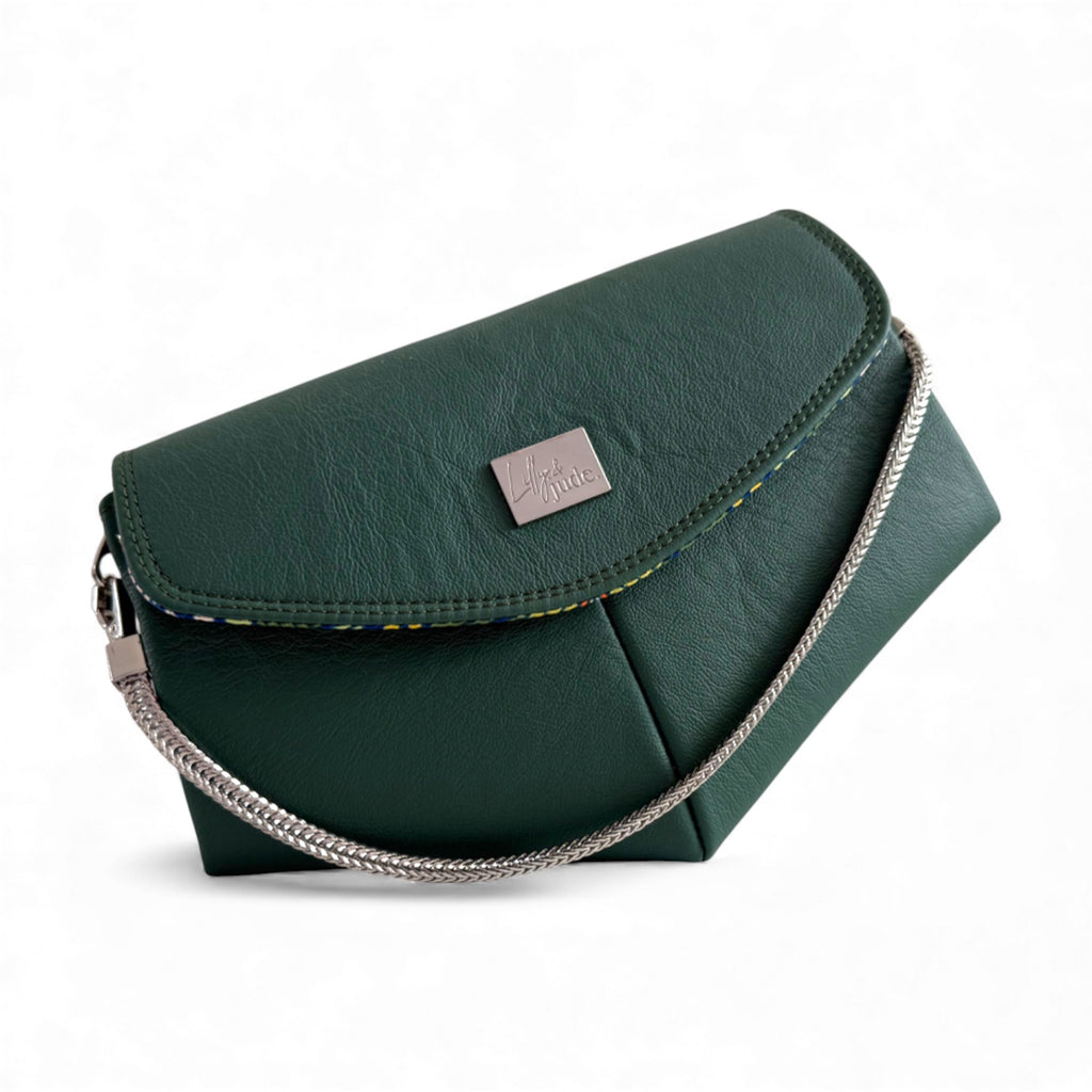 Handcrafted  handbag with a short silver chain strap on a white background. The bag is made from a deep green coloured, genuine leather that has been rescued from heading to landfill