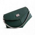 Dark green leather handbag with a short silver chain strap on a white background
