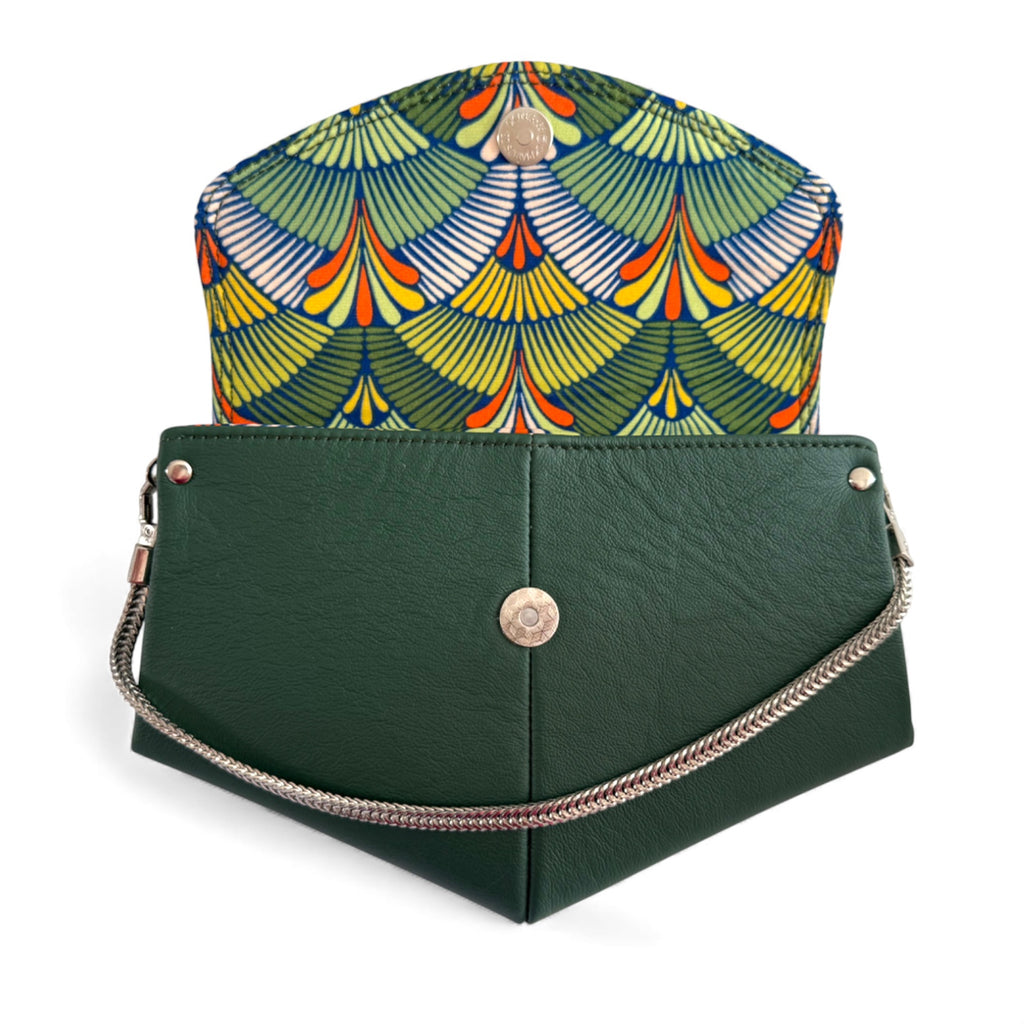 Dark, forest green bag with a bright, orange, yellow and green, fan patterned liningp on a white background. Exclusive to Lilly & Jude