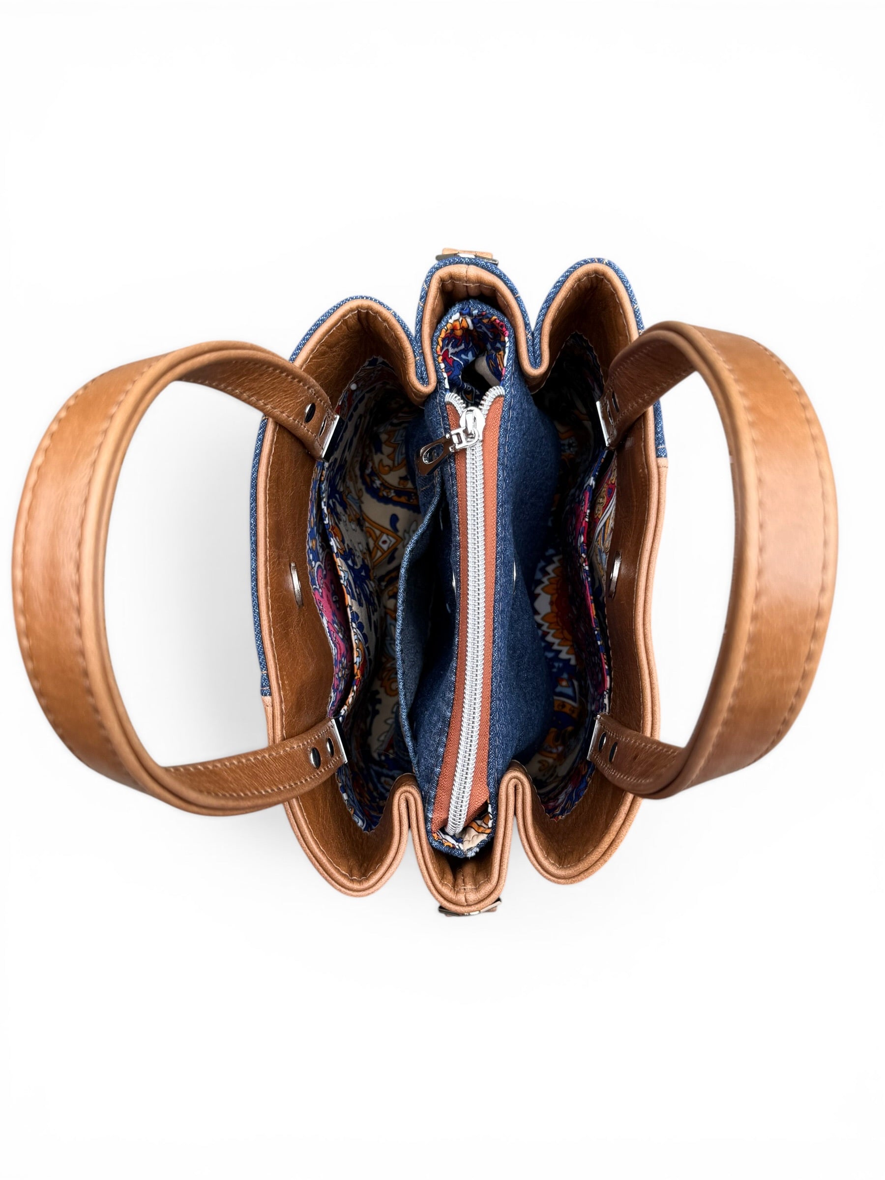 Birds eye view of the denim and leather Soraya handbag, highlighting the three sections of the bag and three slip pockets