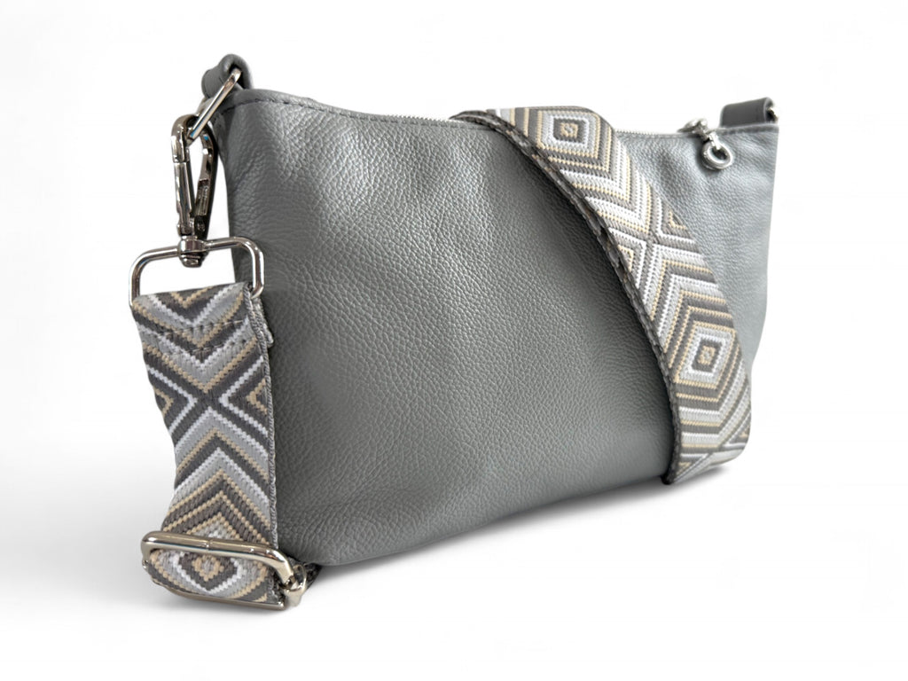 Rear view of the Starburn crossbody bag in pale grey leather and woven adjustable strap and silver hardware